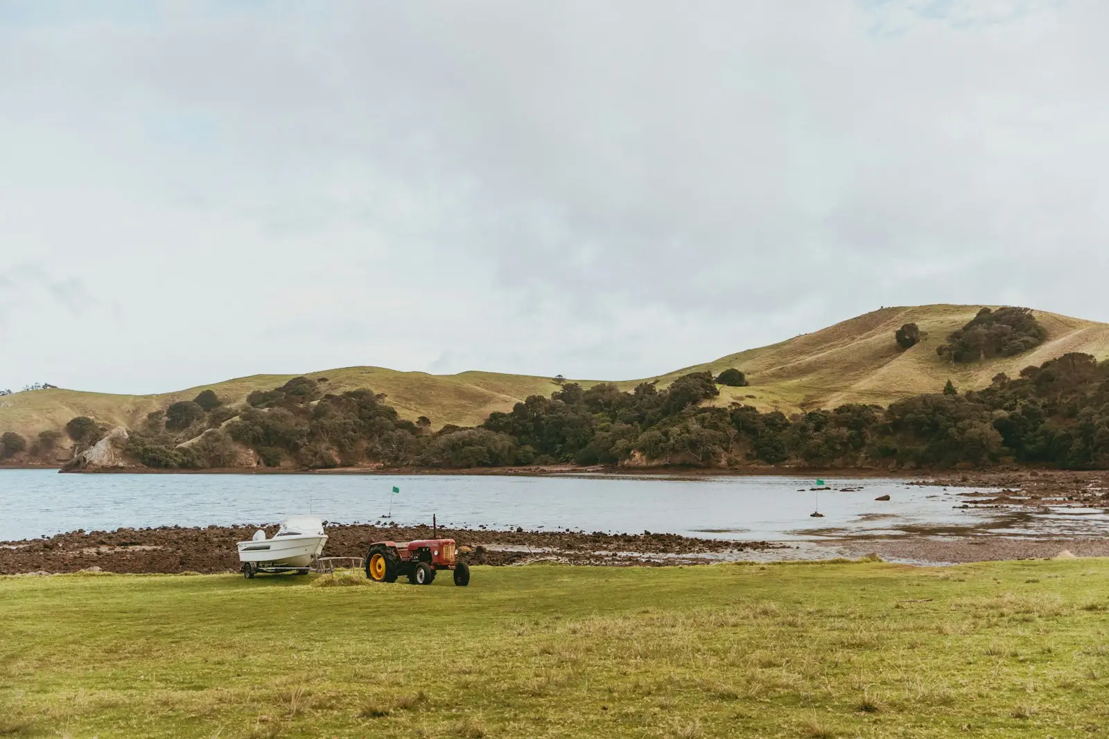 Tractor parked beside the water on a New Zealand farm