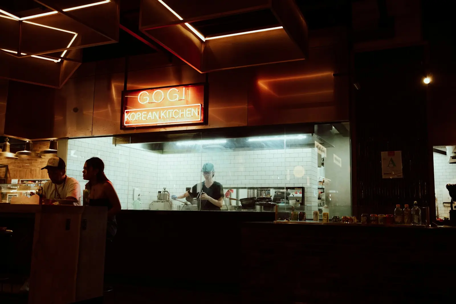 Hospitality owner standing at the counter of a restaurant