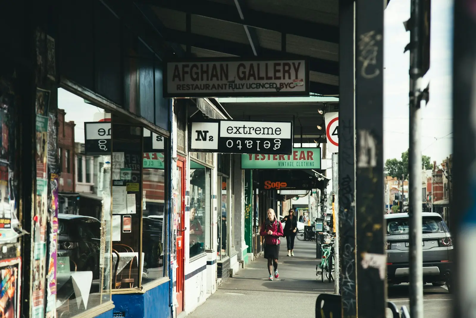 Shopper walking past independent stores